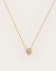A dainty diamond-outlined pendant with a marquise-cut center stone on a delicate yellow gold chain—elegant, lightweight, and endlessly wearable.