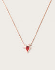 Rose gold necklace featuring a red geometric pendant accented with small diamond details, displayed on a light background.