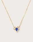 Gold necklace with blue geometric pendant and diamond accents