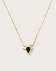 Yellow gold necklace with a black geometric pendant and diamond accents, displayed on a light background.