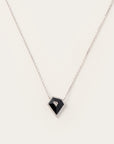 A striking black onyx pendant framed in pavé diamonds, set on a sleek white gold chain—edgy yet timeless, perfect for bold minimalism.