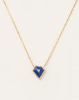 Bold lapis lazuli framed by a halo of diamonds and suspended from a yellow gold chain. A striking blend of rich color and refined sparkle, perfect for everyday icons.
