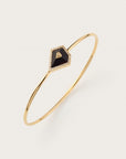 Gold bangle with black geometric stone and diamond border