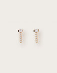 A pair of minimalist yellow gold stud earrings featuring vertical pavé diamond bars topped with horizontally set baguette-cut gemstones, creating a sleek and modern T-shaped design.