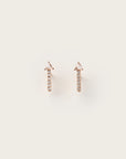 Rose gold stud earrings featuring a vertical line of round diamonds topped with a triangle-cut stone.