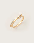 Minimalist yellow gold ring featuring a marquise-cut diamond centerpiece with pavé diamonds along the top band.