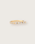 Yellow gold ring with a sleek row of baguette and round diamonds in a modern, tapered setting.