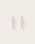 A pair of rose gold earrings featuring vertical pavé diamond bars intersected by soft pink triangle-cut gemstones at the center, creating a modern and elegant silhouette.