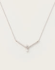 Elegant white gold necklace featuring a V-shaped diamond-accented frame with a pear-cut diamond and a baguette-cut diamond pendant.