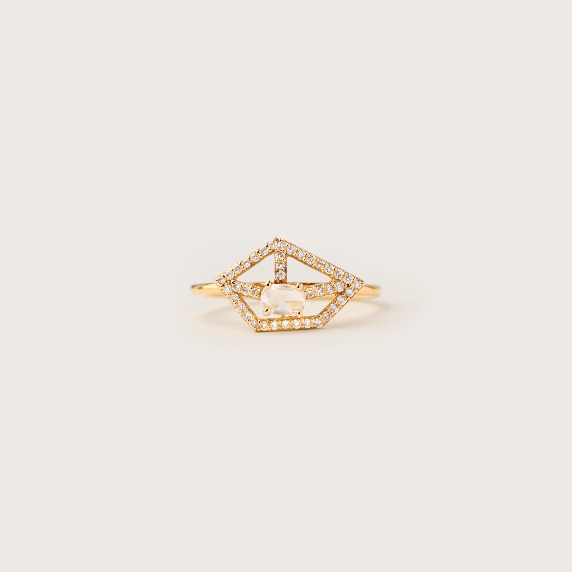 A delicate 18K yellow gold ring featuring a geometric openwork design with pavé-set diamonds, centered around a captivating rose-cut diamond. Inspired by celestial constellations, this modern yet timeless ring exudes refined elegance.